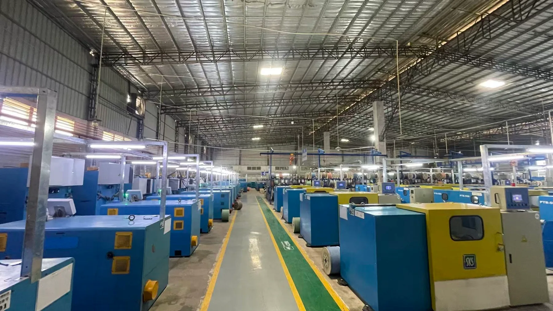 Wide view across a NexBridge partner cable factory floor